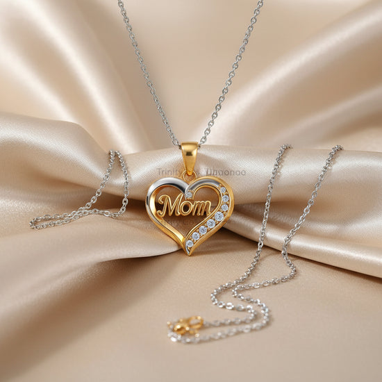 A heart-shaped pendant necklace with a gold and silver split design, featuring the word &