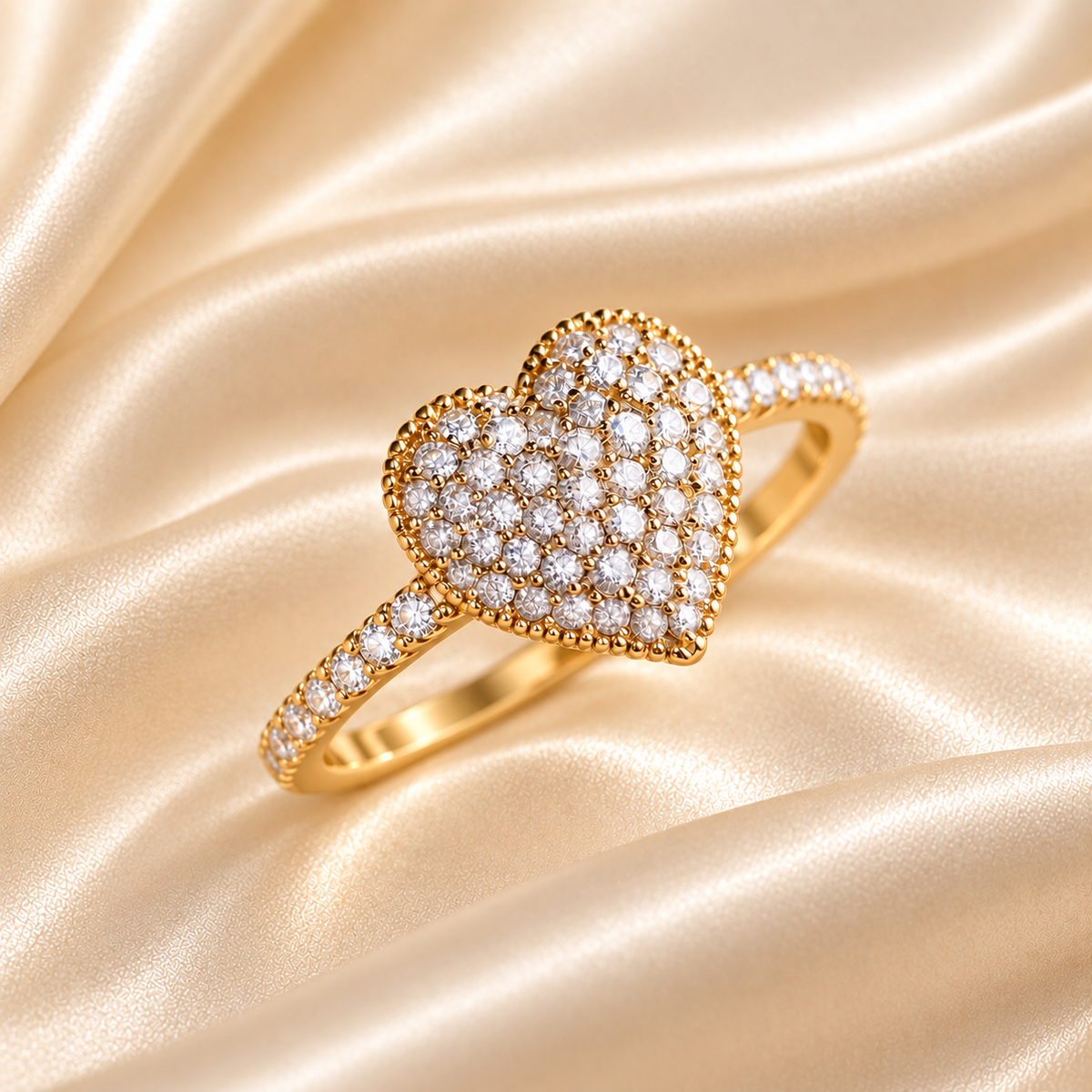 A dainty heart-shaped ring with moissanite diamonds on a sterling silver band, displayed on a person&