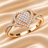 A heart-shaped Moissanite diamond ring with 14KT gold plating on a silver band, displayed against a gradient background.